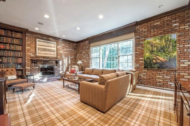 living room featuring crown molding, a fireplace, built in shelves, and brick wall