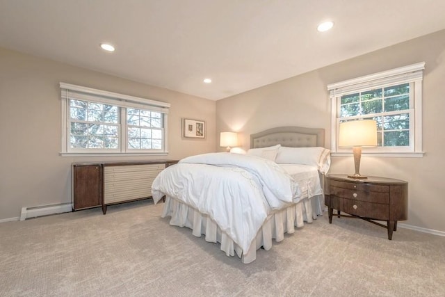 carpeted bedroom featuring multiple windows and a baseboard radiator