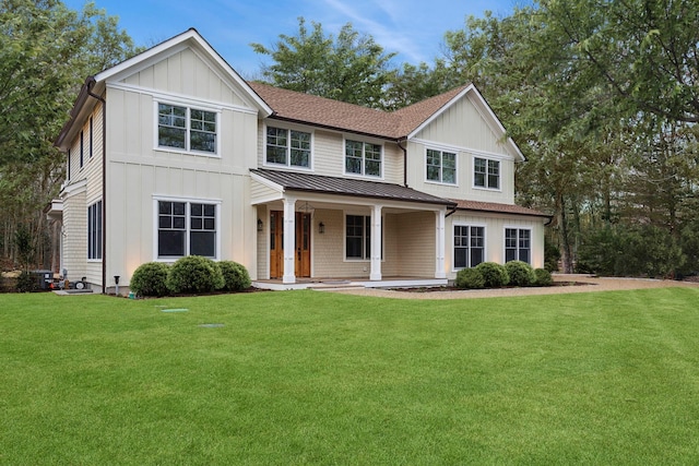 view of front of property featuring a front yard and covered porch