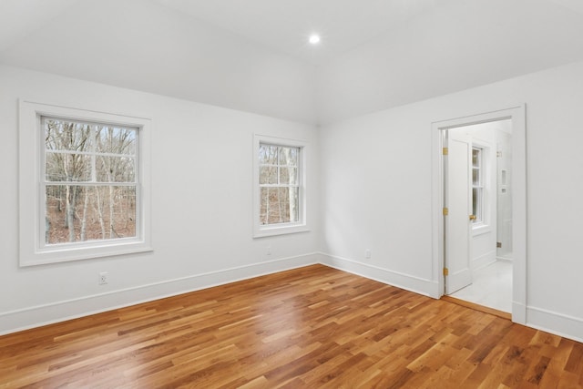 unfurnished bedroom with multiple windows and light wood-type flooring