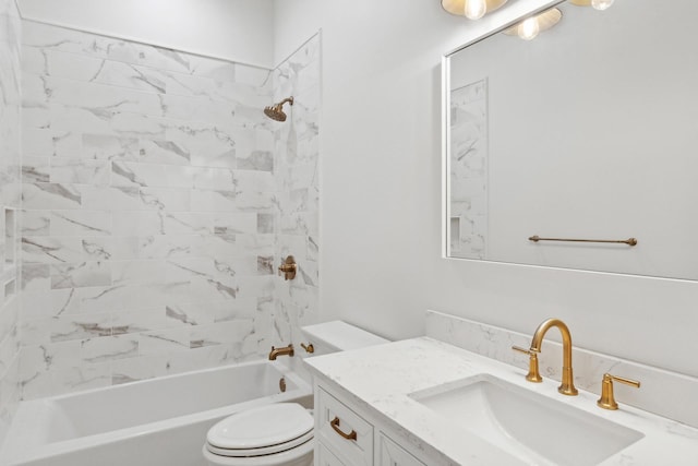 full bathroom featuring tiled shower / bath, vanity, and toilet