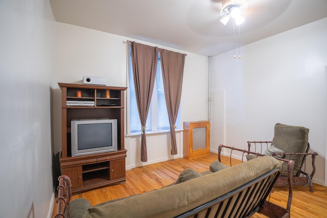 living room featuring ceiling fan and hardwood / wood-style floors