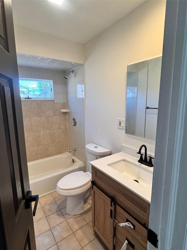 full bathroom featuring toilet, vanity, tile patterned floors, and tiled shower / bath combo