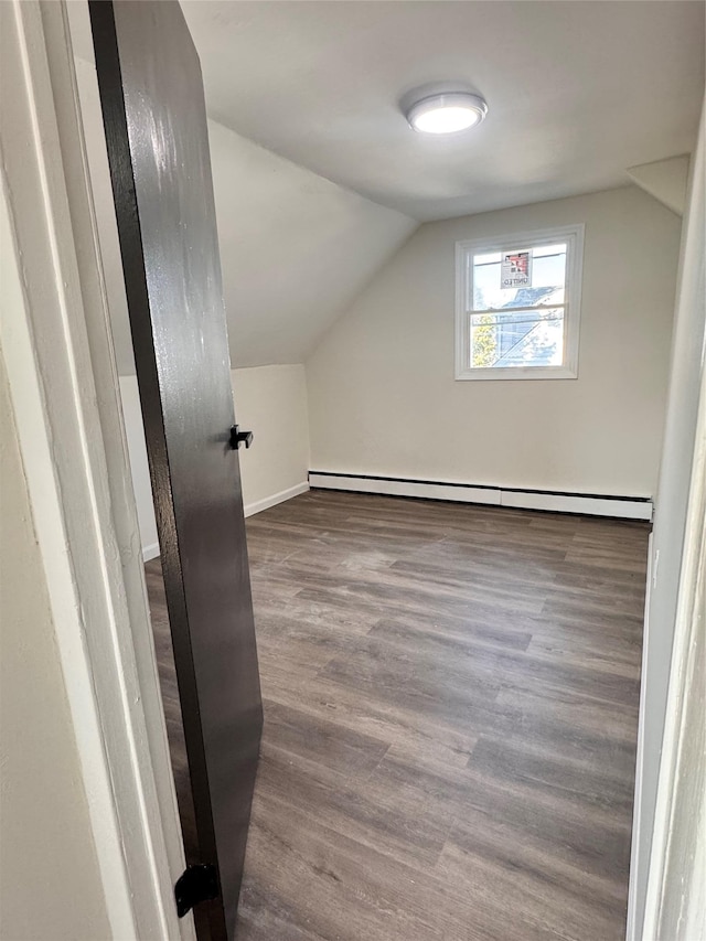 bonus room with hardwood / wood-style floors, a baseboard radiator, and lofted ceiling