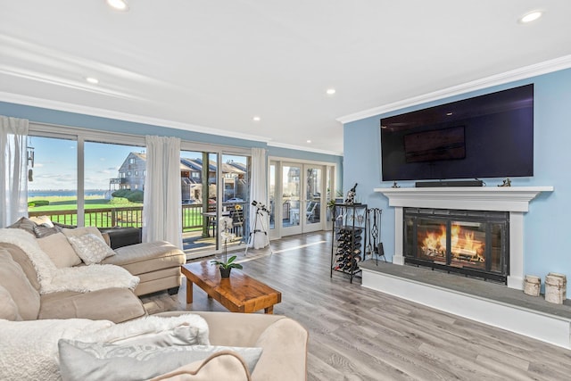 living room featuring crown molding, hardwood / wood-style flooring, and french doors