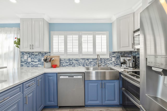 kitchen featuring sink, stainless steel appliances, white cabinets, and blue cabinets