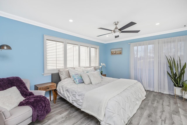 bedroom with crown molding, ceiling fan, and light hardwood / wood-style flooring