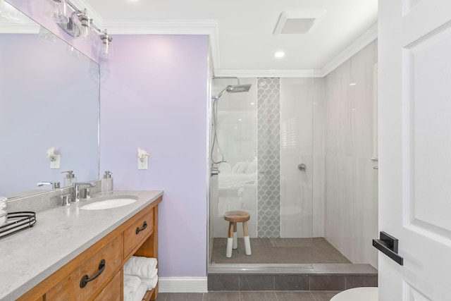 bathroom with crown molding, tiled shower, and vanity