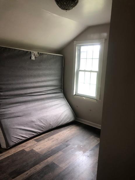 24 Wagner St, Call Listing Agent, NY 13339 - unfurnished bedroom with lofted ceiling and wood finished floors