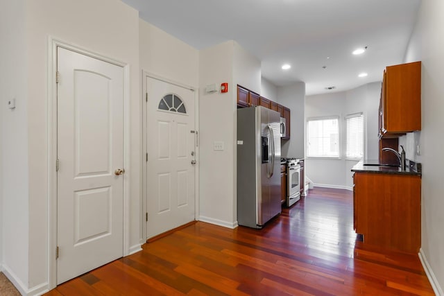 hallway with dark hardwood / wood-style flooring and sink