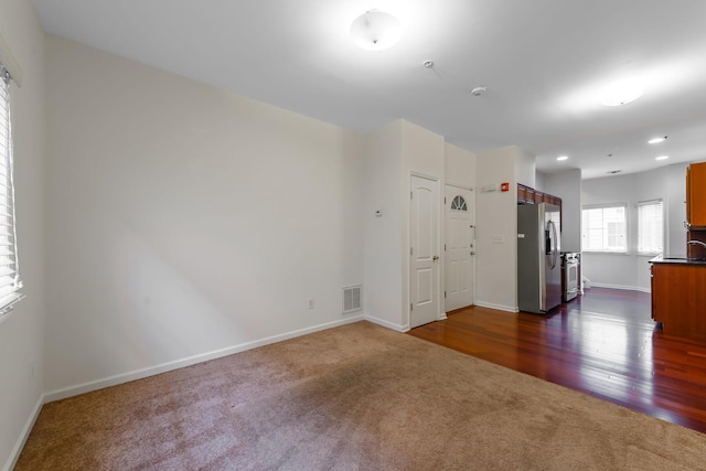 empty room featuring dark carpet