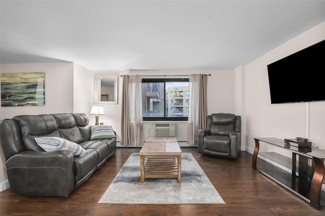 living room featuring dark hardwood / wood-style flooring, an AC wall unit, and baseboard heating