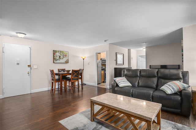 living room with dark hardwood / wood-style flooring