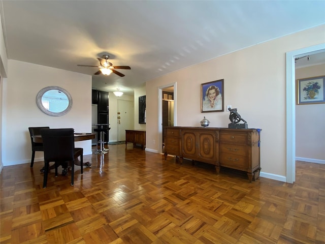 dining area featuring dark parquet flooring and ceiling fan