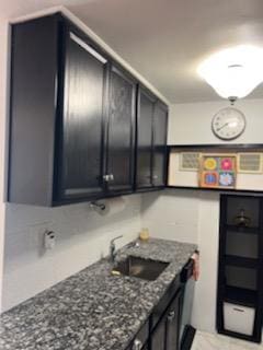 kitchen with dark stone countertops and sink