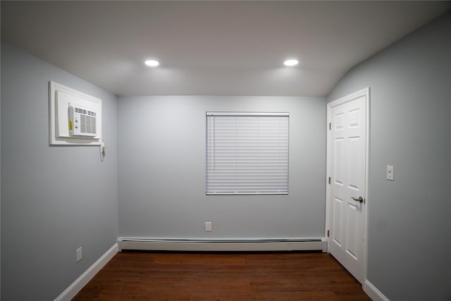 unfurnished room featuring a wall unit AC, dark hardwood / wood-style flooring, and a baseboard radiator