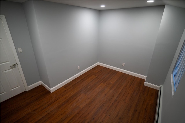 spare room with dark hardwood / wood-style floors