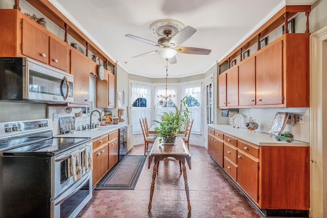 kitchen with stainless steel appliances, sink, ornamental molding, ceiling fan with notable chandelier, and hanging light fixtures