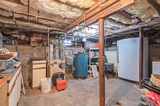 basement featuring fridge and water heater