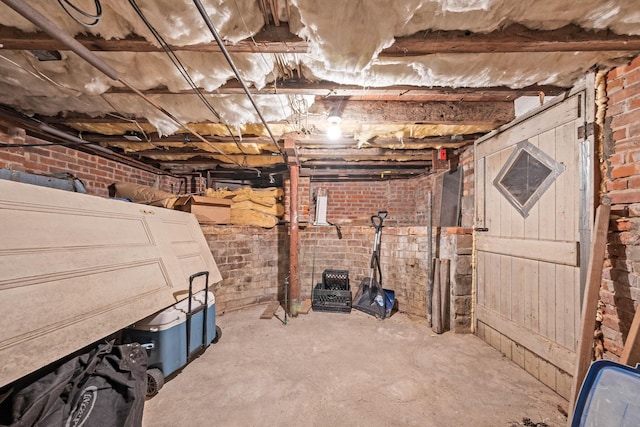 basement featuring brick wall