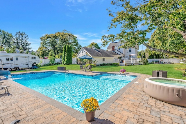 view of swimming pool featuring a patio, an in ground hot tub, and a yard