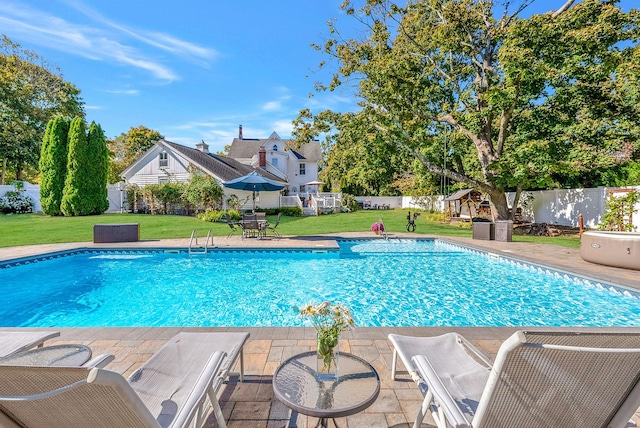 view of swimming pool with a patio area and a yard