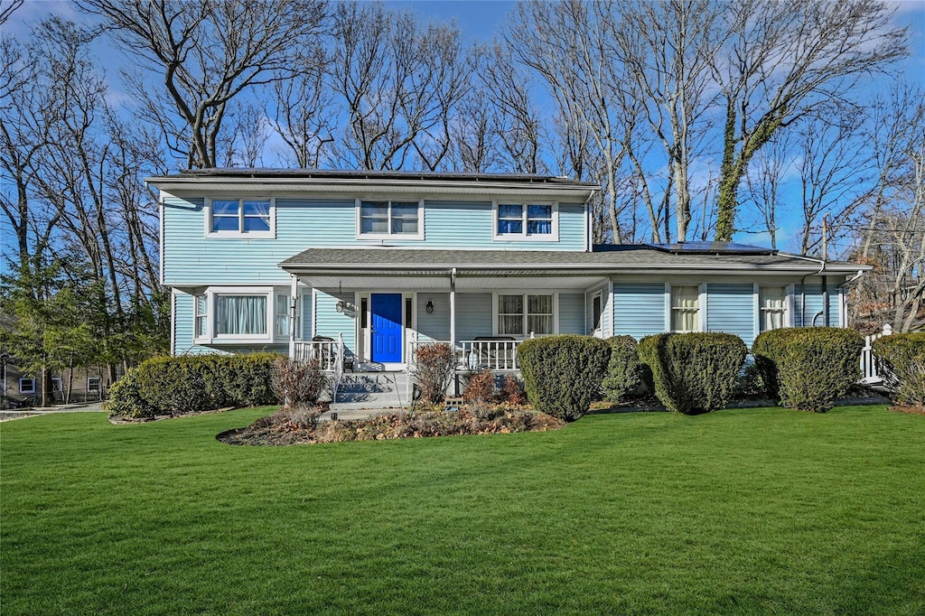 view of front of home featuring covered porch and a front yard