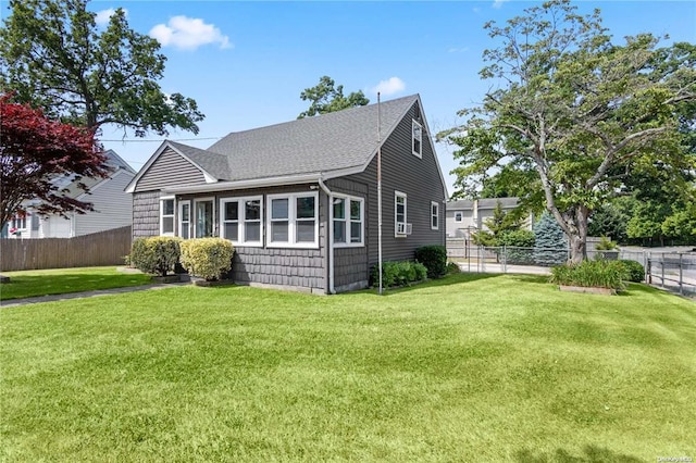 rear view of property with a lawn