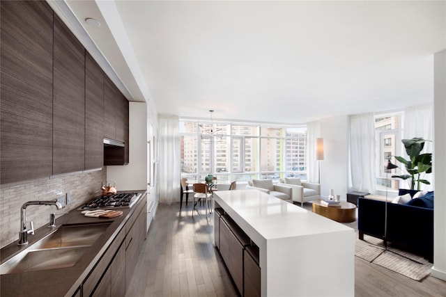 285 W 110th St Unit 2A, New York Manhattan, NY 10026 - kitchen with a sink, modern cabinets, stainless steel gas stovetop, wood finished floors, and decorative backsplash