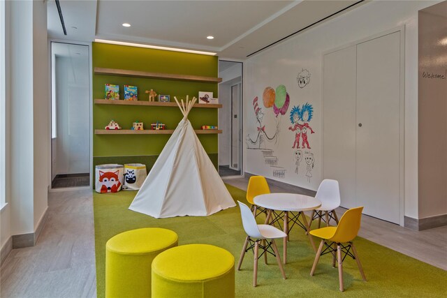 recreation room with light hardwood / wood-style flooring