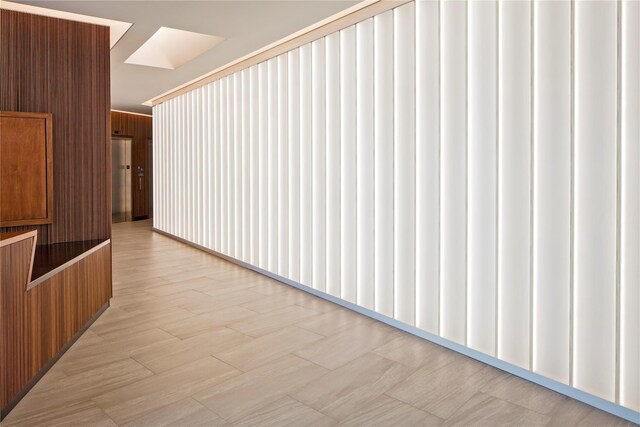 hallway with wood walls