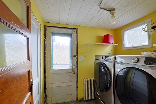 clothes washing area with washing machine and dryer, wood ceiling, and radiator heating unit