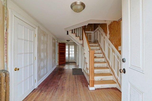 stairs featuring hardwood / wood-style floors