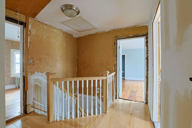 corridor with radiator and light wood-type flooring