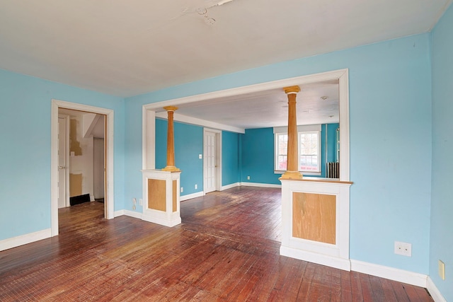 unfurnished living room with dark hardwood / wood-style flooring