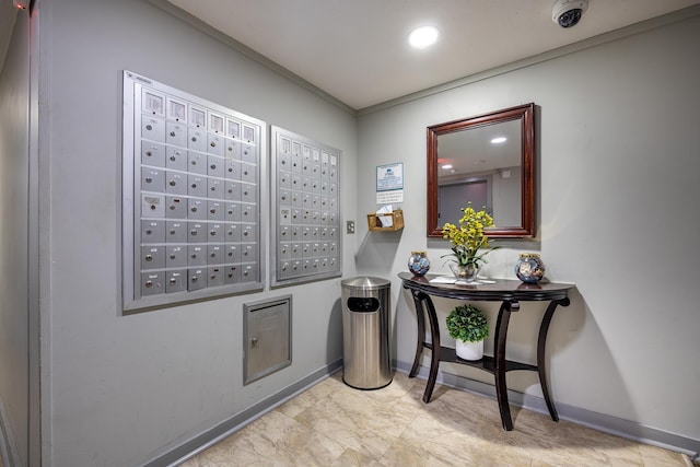 hallway with ornamental molding and a mail area