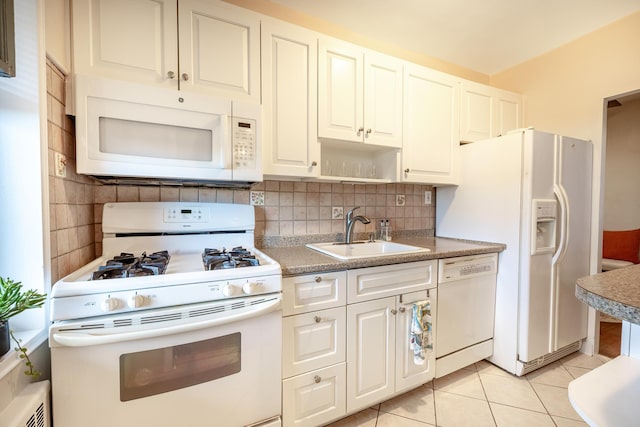 kitchen with decorative backsplash, white appliances, sink, light tile patterned floors, and white cabinets