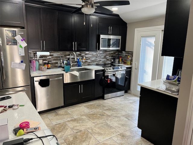 kitchen featuring ceiling fan, stainless steel appliances, tasteful backsplash, and sink