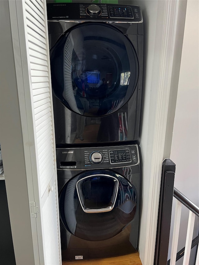 washroom featuring stacked washer and clothes dryer