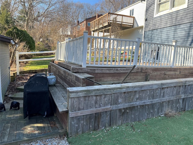 wooden deck with a grill