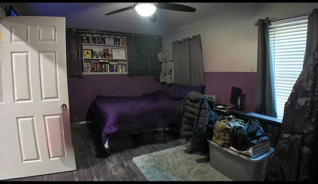 bedroom featuring dark wood-type flooring and ceiling fan