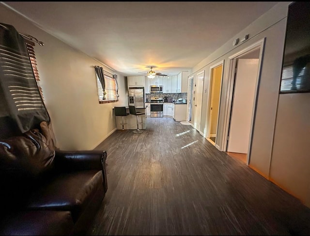 unfurnished living room featuring hardwood / wood-style floors and ceiling fan