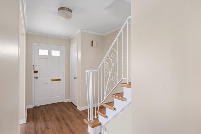 entrance foyer with dark hardwood / wood-style flooring and crown molding