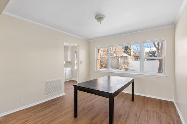 office featuring hardwood / wood-style flooring and crown molding