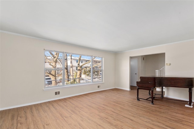 interior space featuring light hardwood / wood-style floors and crown molding