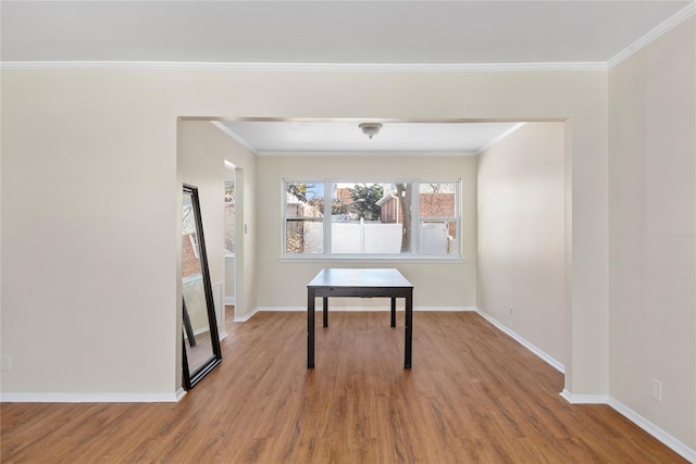 dining room with ornamental molding and hardwood / wood-style floors