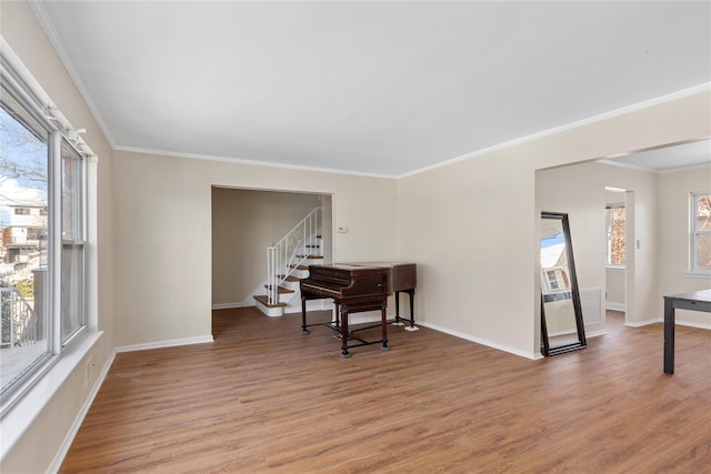 living area with hardwood / wood-style floors and crown molding