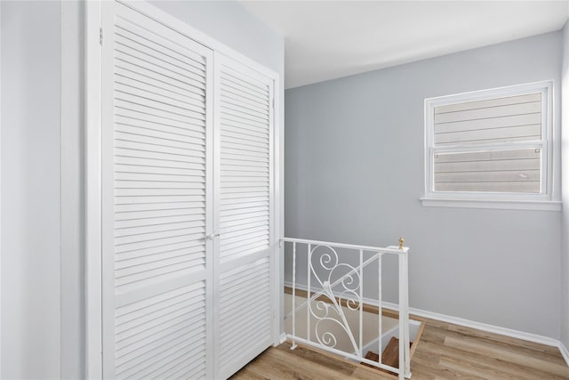 corridor with hardwood / wood-style flooring