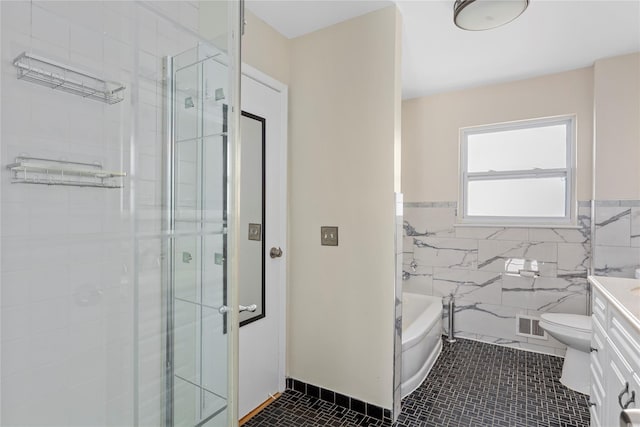 full bathroom with tile patterned flooring, vanity, tile walls, and shower with separate bathtub