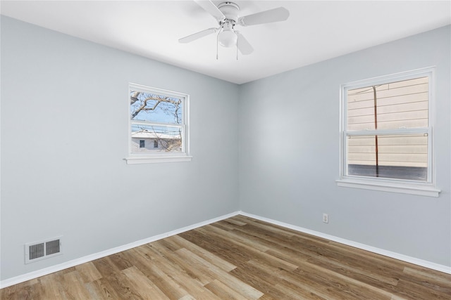 spare room with ceiling fan and hardwood / wood-style floors